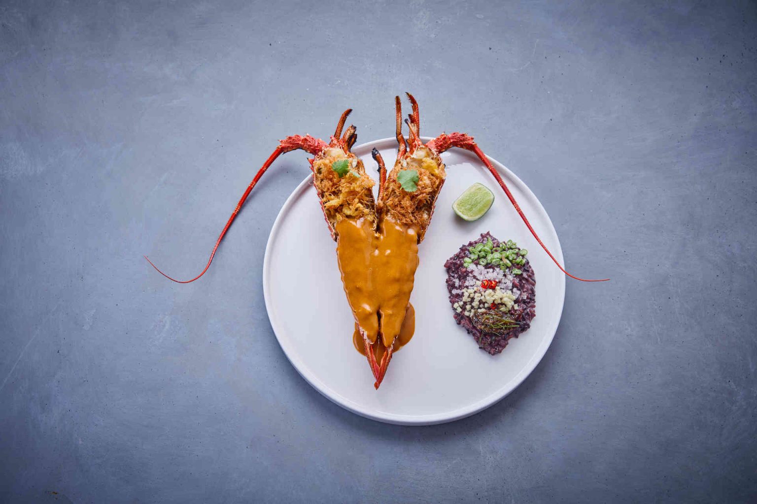 Crayfish, tom yam bisque, crispy egg and black rice © Helge Kirchberger Photography