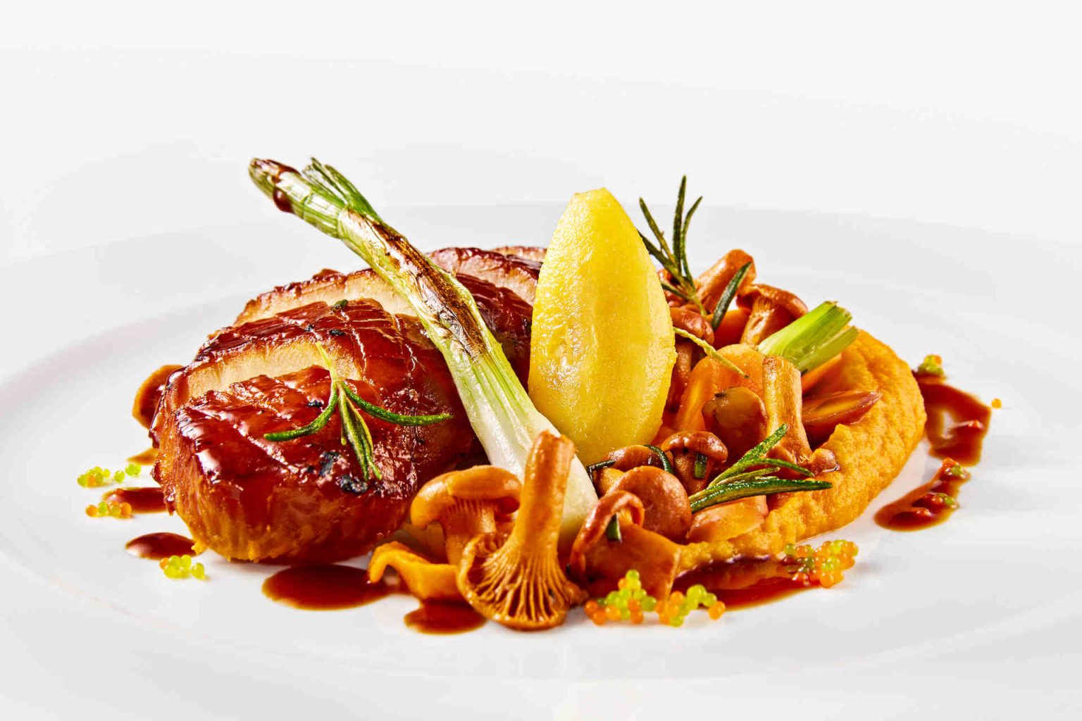 Vegetarian main course: Glazed celery steak and sautéed chanterelles, photo provided, with Riesling apples, carrot cream, and exotic “caviar”, photo provided