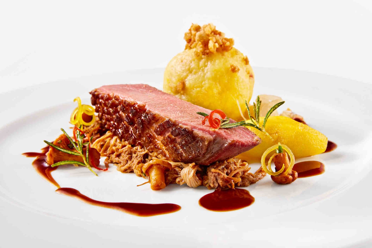 Main course: Duck duet – pink roasted breast and confit ragout – with Riesling apples, champagne cabbage, honey jus, and potato dumplings, photo provided