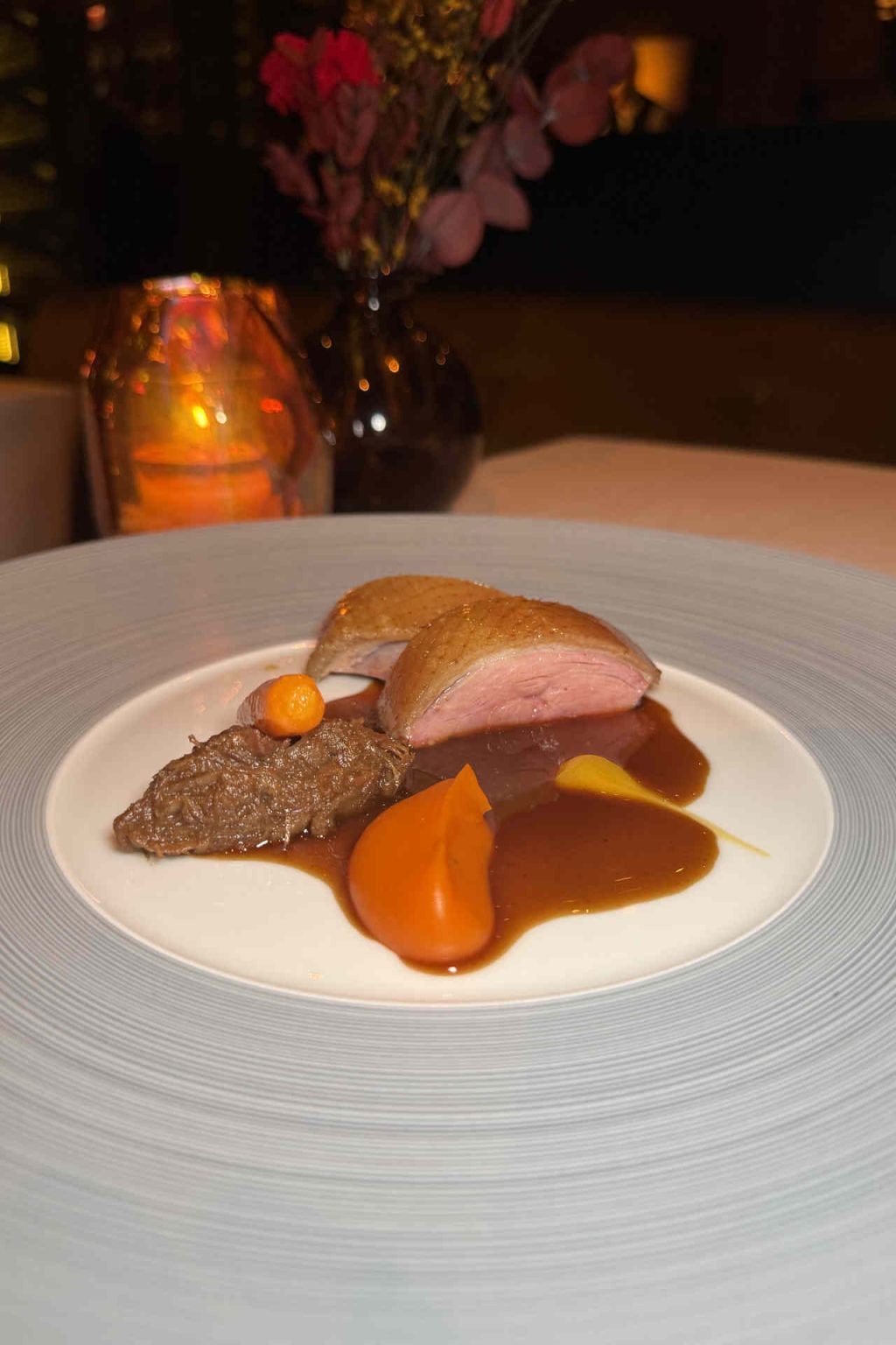 Peking duck, mandarin orange, and Cheong carrot © Genusspunkt